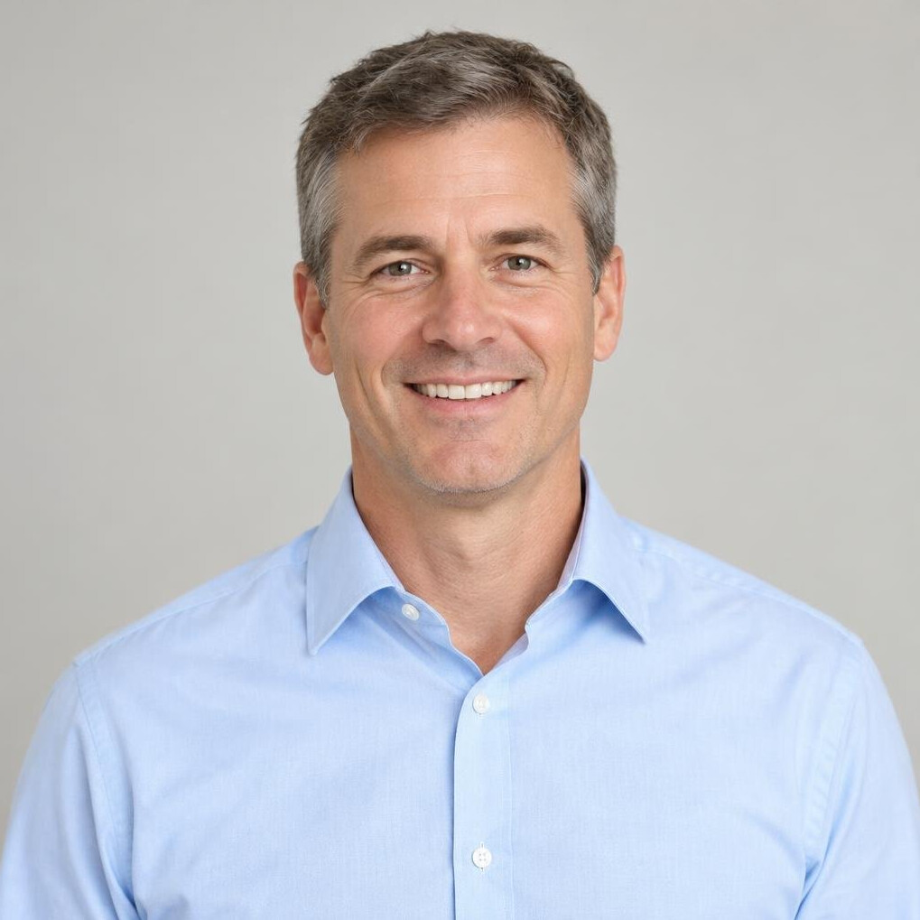 Portrait of a man in a light shirt smiling